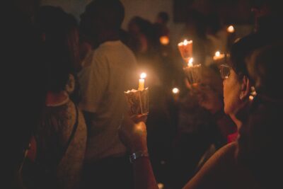 people holding candles at nighttime