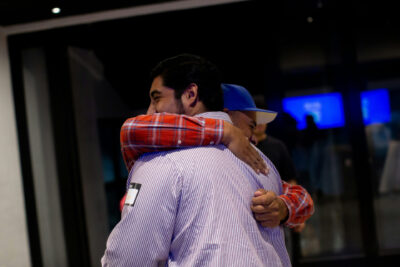 Two men hugging during a church service